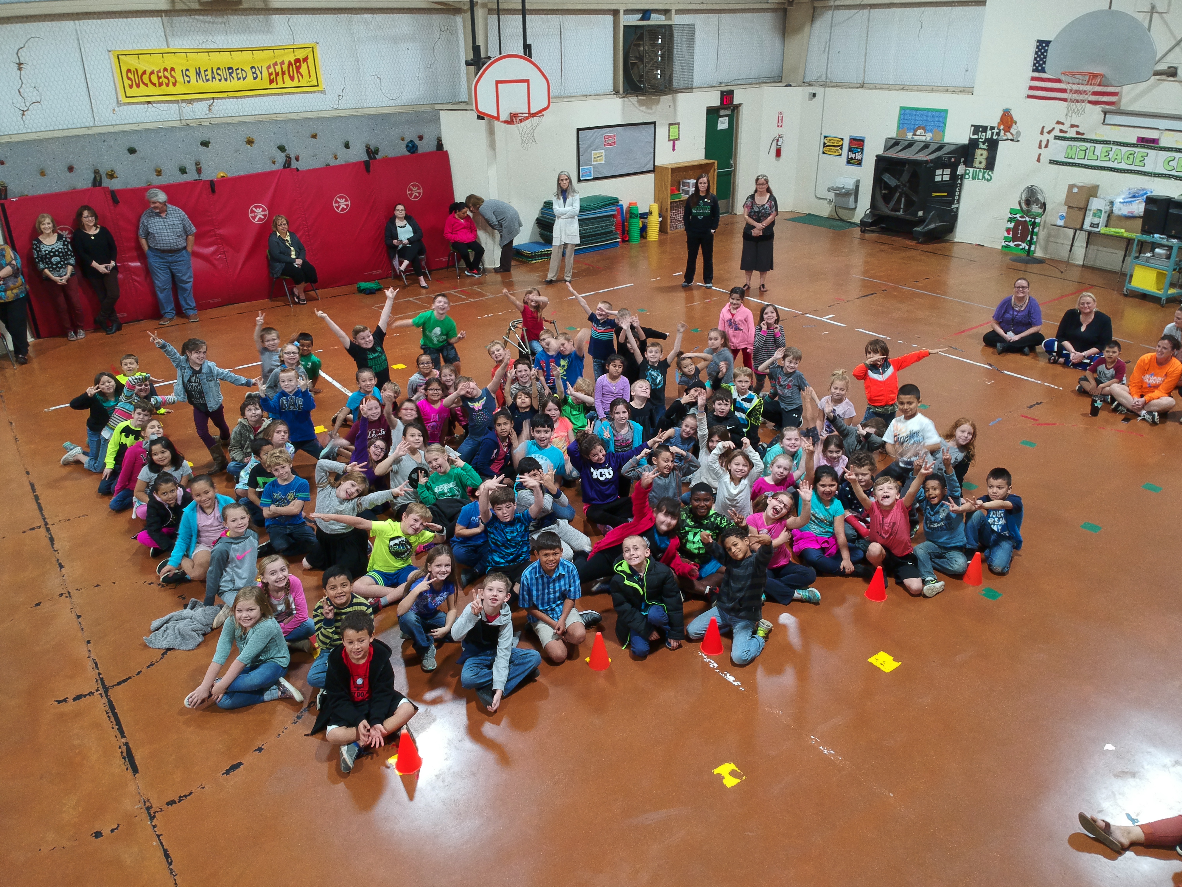 A gymnasium packed with kids watching a Wondergy assembly