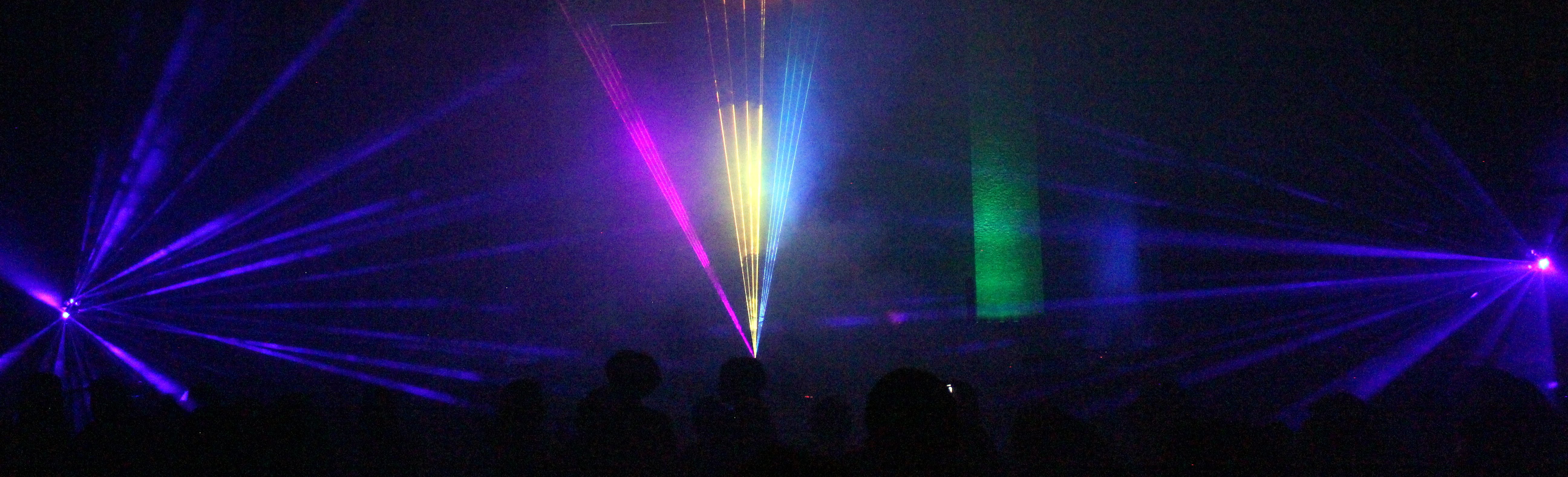 A sanctuary filled with fans of laser light over a rapt audience